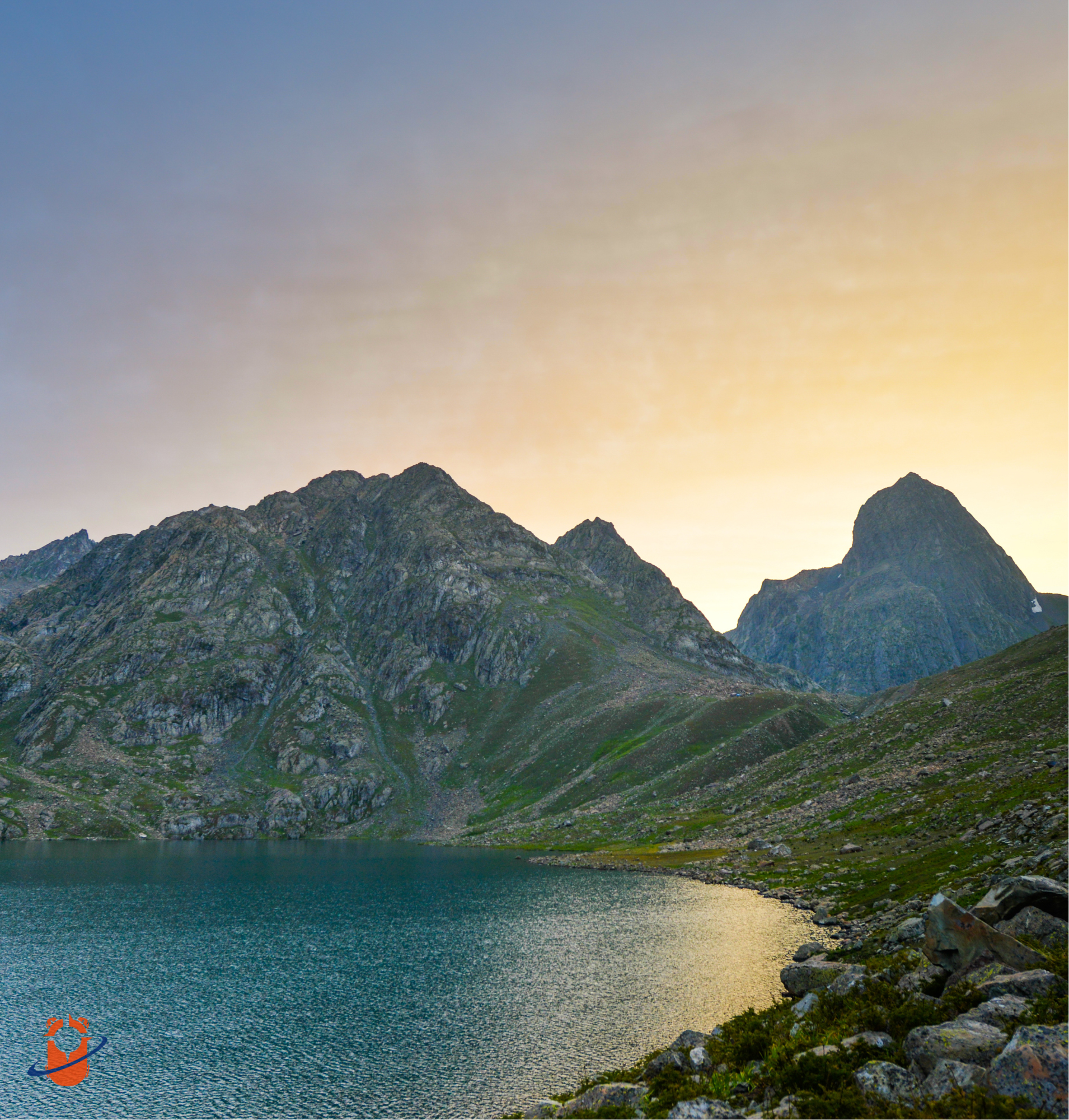 Trekkers walking beside alpine lake during Kashmir Great Lakes trek in Kashmir, India